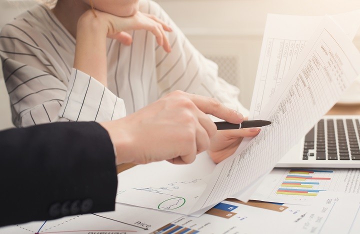 Two people analysing the diagrams and data