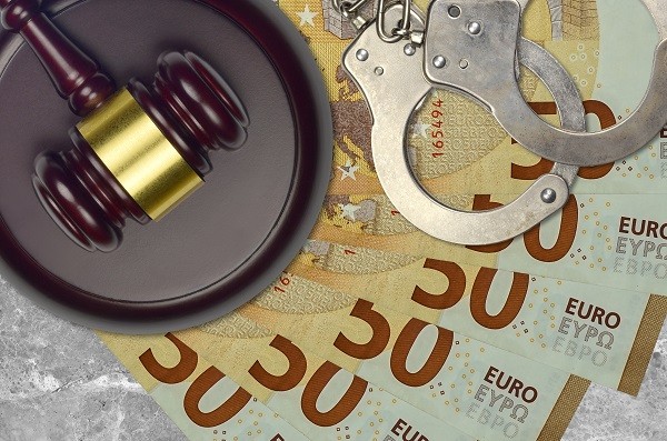 Euro dollars, handcuffs, gavel and sound block