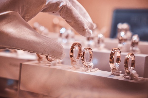 A hand picking a diamond from the display cabinet