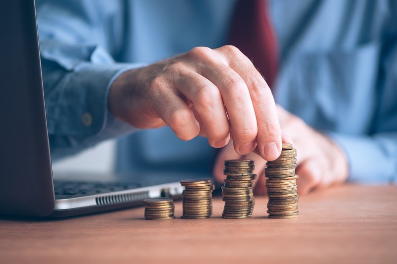 A man picking up coins from the table