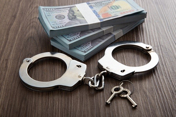 Handcuffs and money on table