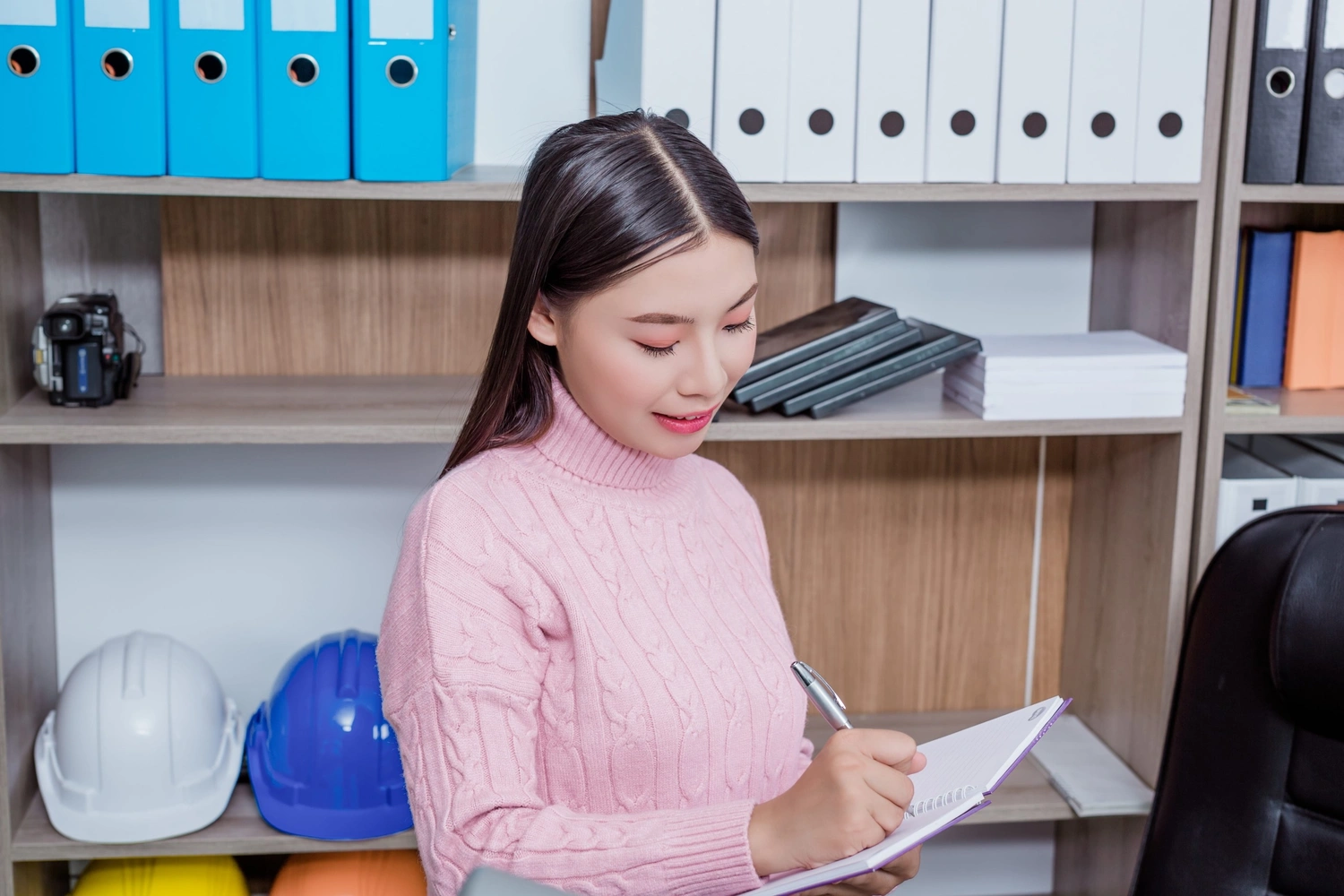 Business consultant handing regulatory documents to a client during a corporate advisory meeting.