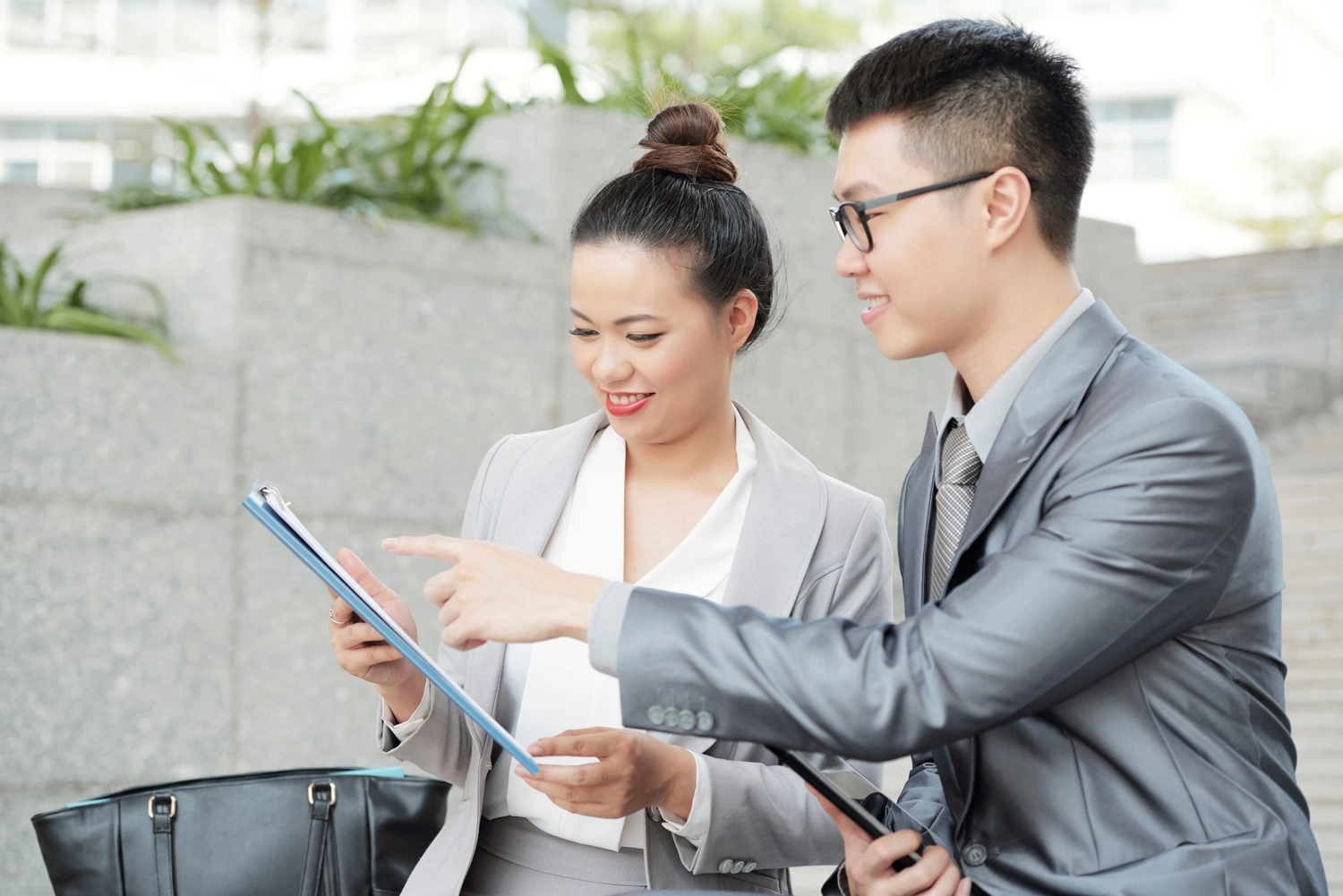 Business consultants discussing outsourced compliance services for regulated businesses.