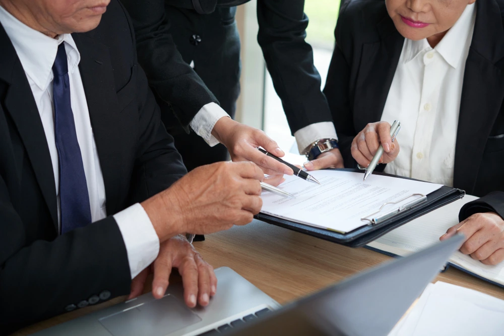 Fund manager and adviser reviewing scheme documentation