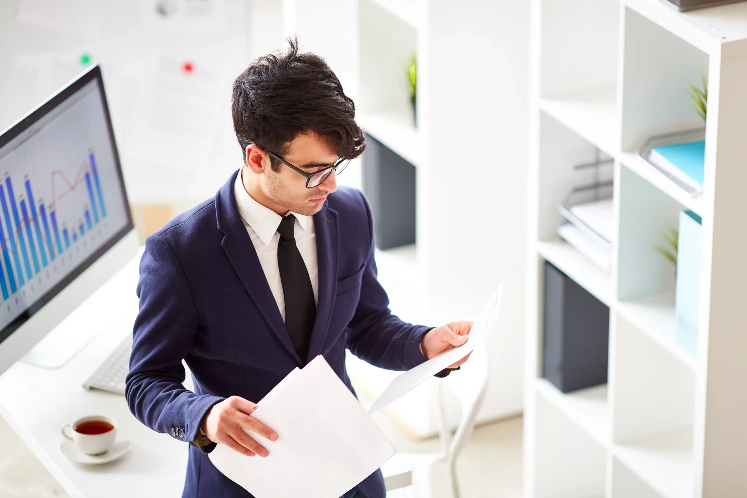 Financial professional reviewing regulatory documents relating to MAS retail fund approvals.