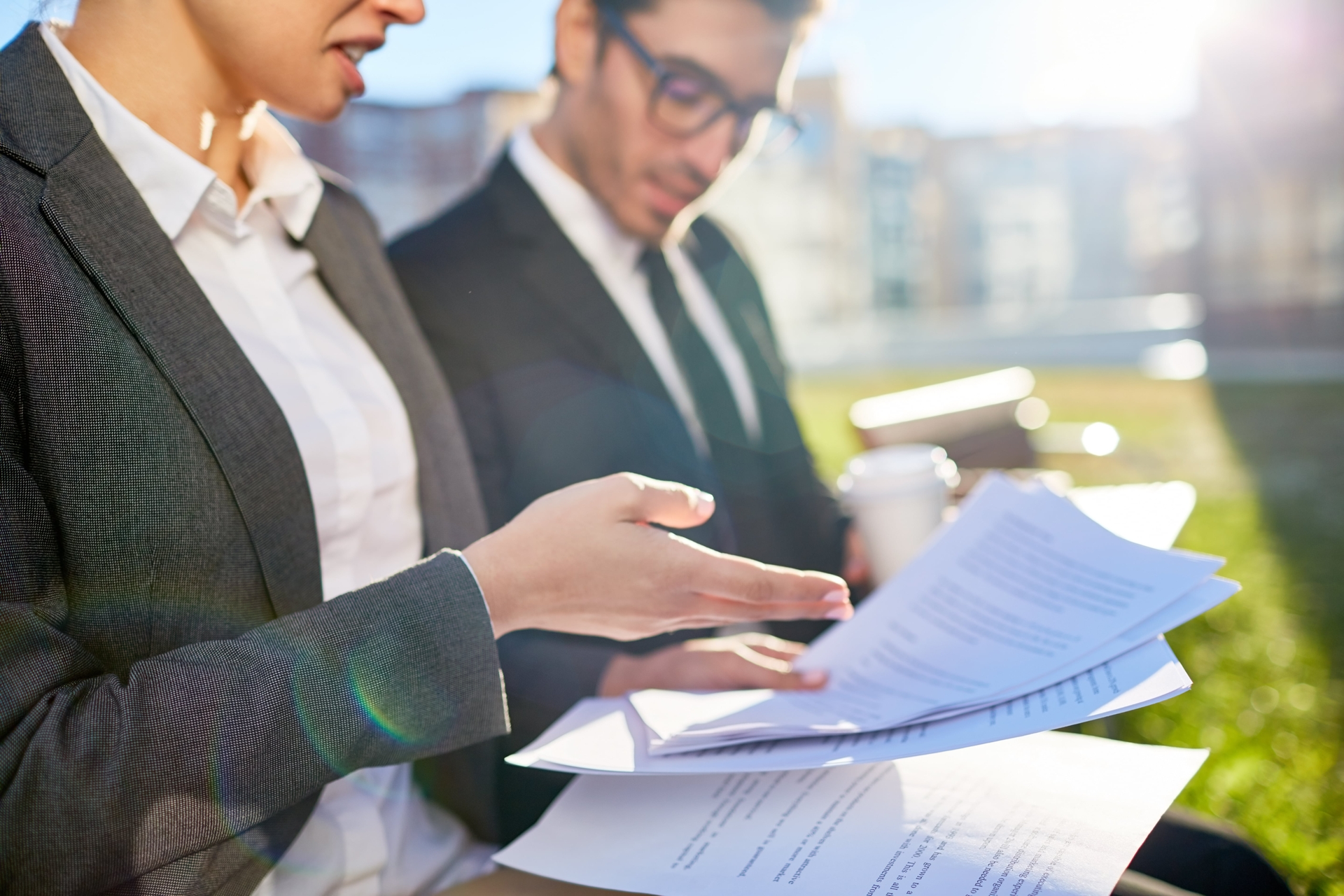 Business professional reviewing compliance documents for sanctions screening and regulatory checks.