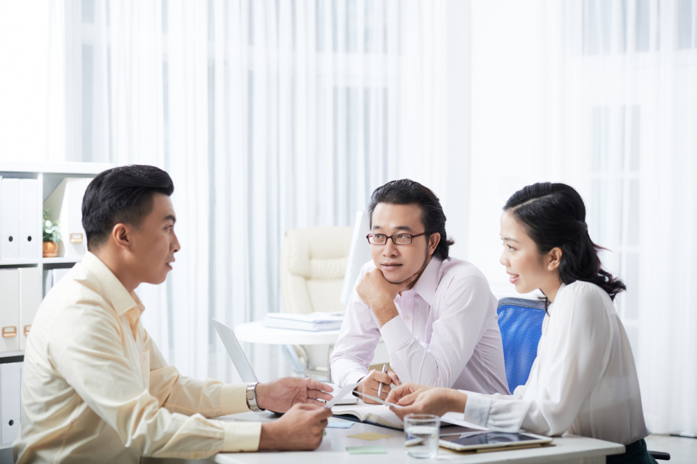 Compliance team reviewing Singapore MAS fund management compliance framework and business documentation