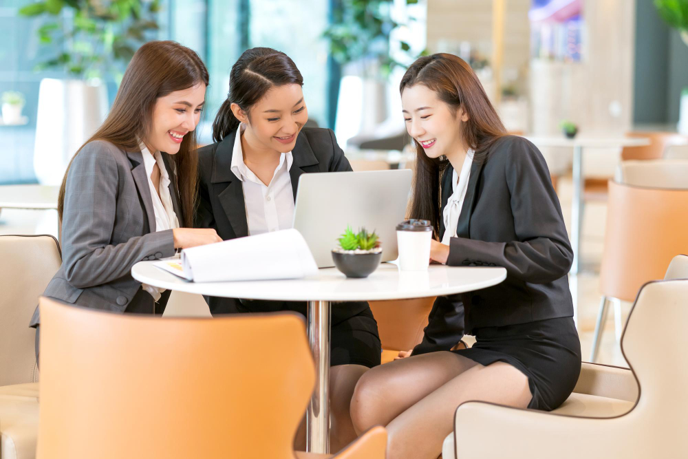 Professional financial advisory team reviewing MAS licence compliance documents in a cafe