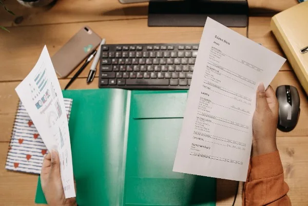 Financial executive conducting deep-dive audit on bespoke MAS compliance manual documents at desk